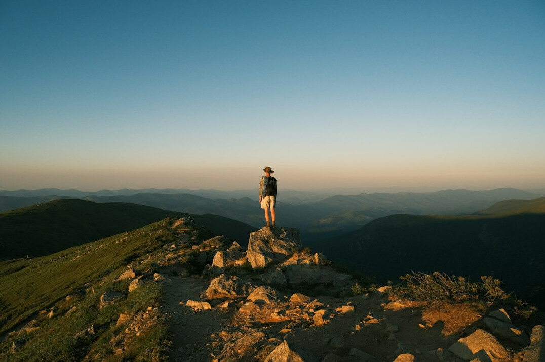 person standing on mountain peak